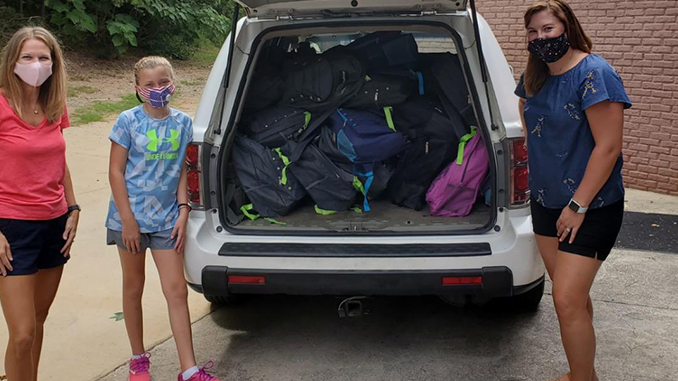 A trunkful of backpacks