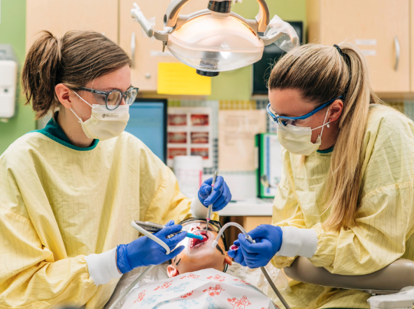 Photo of two dental students at a previous year's event (UAB Dentistry News)